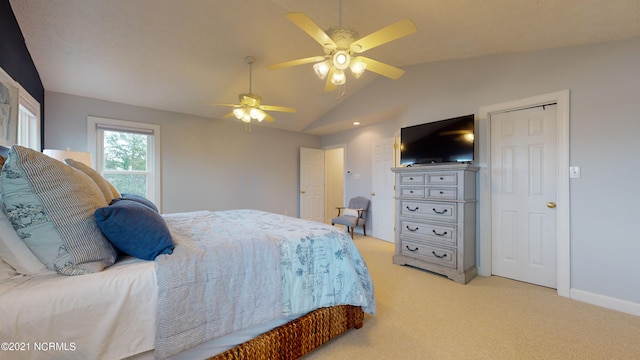 bedroom with ceiling fan, light carpet, and lofted ceiling