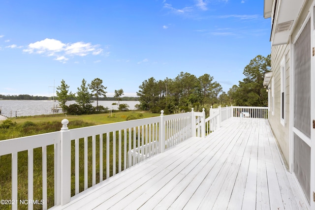 deck with a lawn and a water view