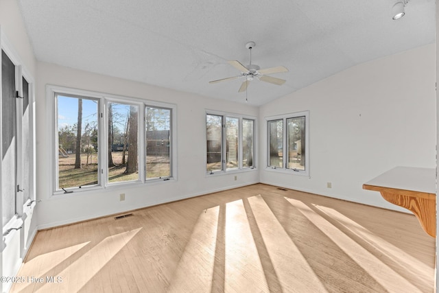 unfurnished sunroom with ceiling fan and lofted ceiling