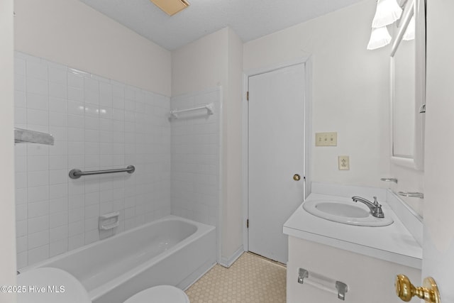 full bathroom featuring toilet, vanity, bathtub / shower combination, and a textured ceiling