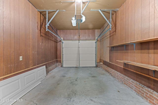 garage with a garage door opener and wood walls