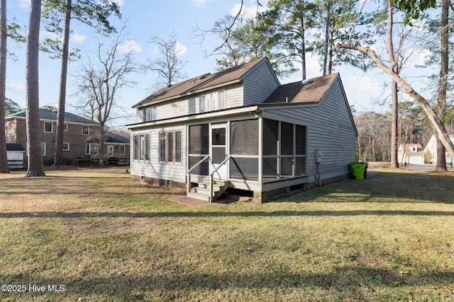 back of house featuring a yard and a sunroom