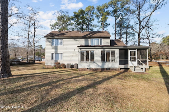 rear view of house featuring a sunroom, cooling unit, and a lawn