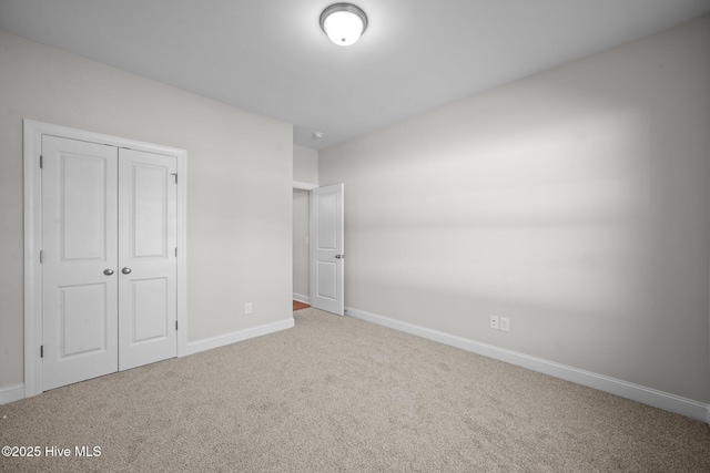 unfurnished bedroom with a closet and carpet