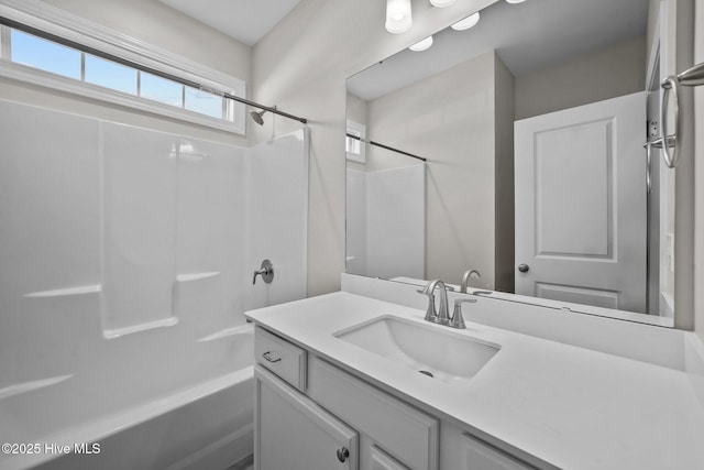 bathroom featuring vanity and  shower combination