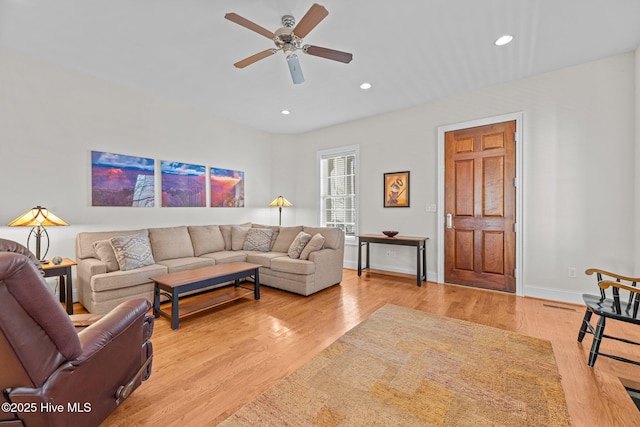 living room featuring ceiling fan and light wood-type flooring