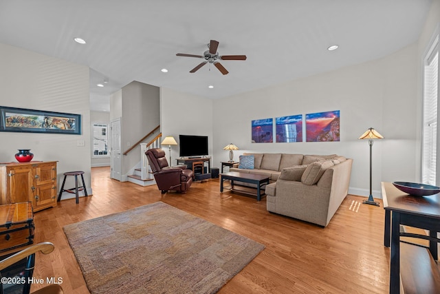 living room featuring ceiling fan and light wood-type flooring