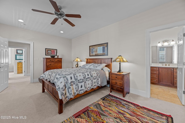 carpeted bedroom with ceiling fan and ensuite bath