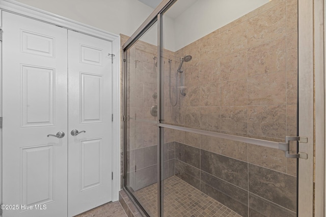 bathroom featuring a shower with door