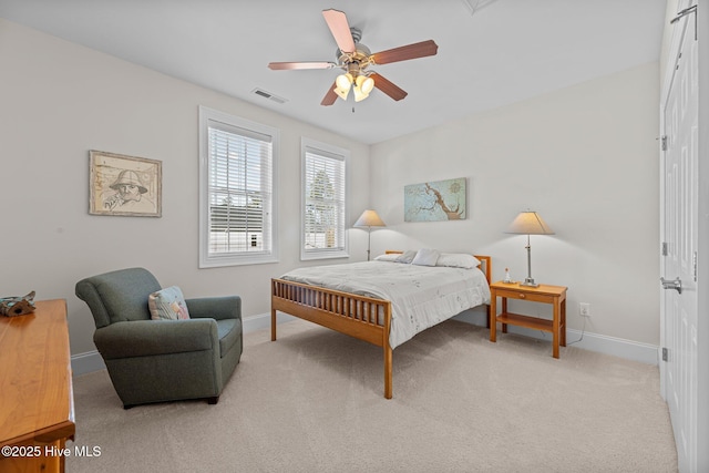 bedroom with ceiling fan and light carpet