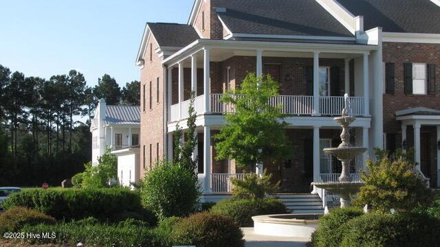 view of front of house featuring covered porch and a balcony