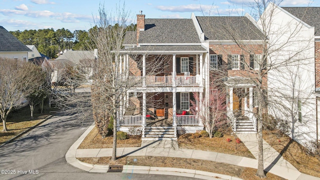 view of front of house with covered porch and a balcony