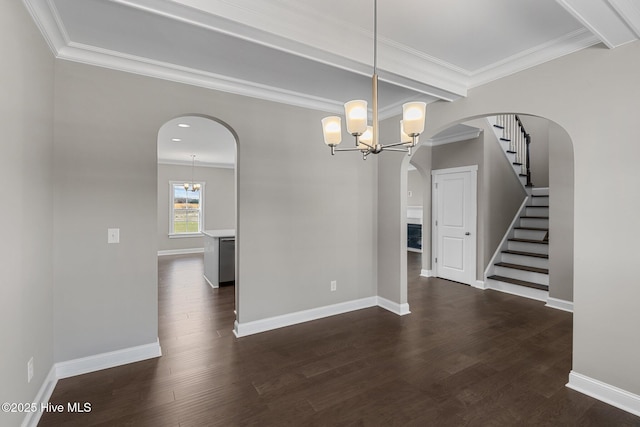 unfurnished dining area with a chandelier, dark hardwood / wood-style floors, and ornamental molding