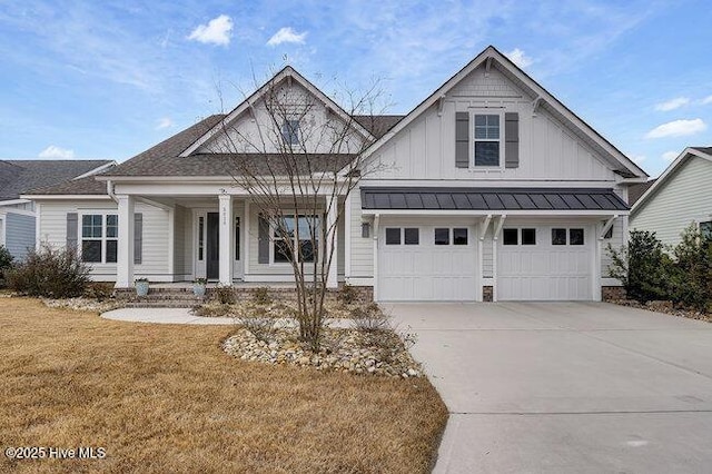 view of front facade with covered porch, a garage, and a front yard