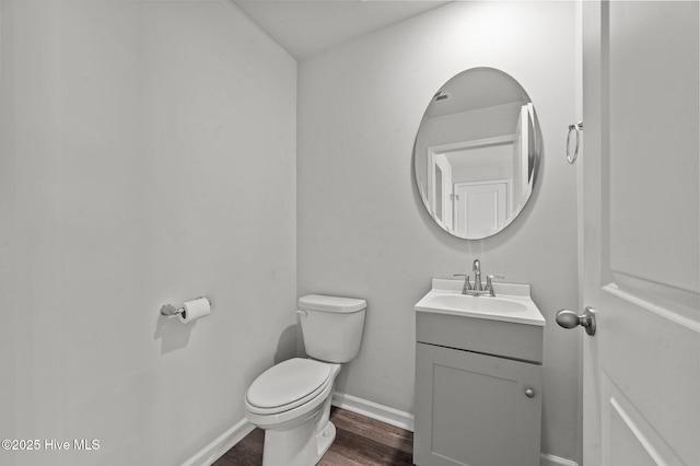 bathroom featuring hardwood / wood-style floors, vanity, and toilet