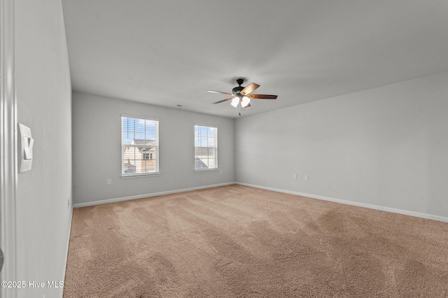 carpeted spare room with ceiling fan