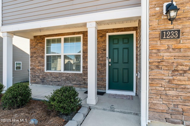 doorway to property featuring a porch