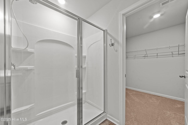 bathroom featuring a shower with shower door