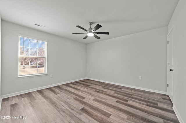 spare room with hardwood / wood-style floors and ceiling fan