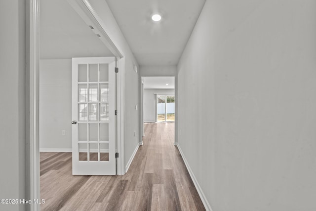 hallway with light hardwood / wood-style flooring