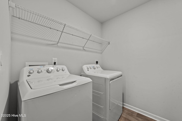 laundry room featuring washing machine and dryer and dark hardwood / wood-style floors