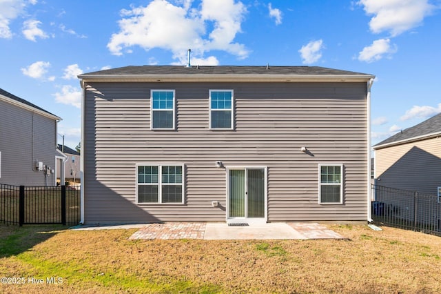 rear view of property featuring a yard and a patio