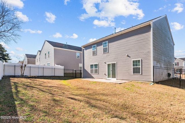 rear view of property with a yard and a patio