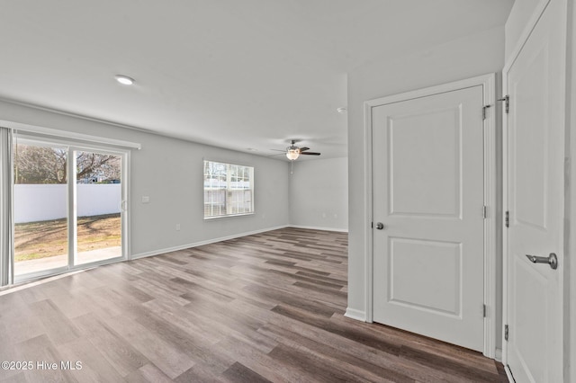 spare room with ceiling fan and wood-type flooring