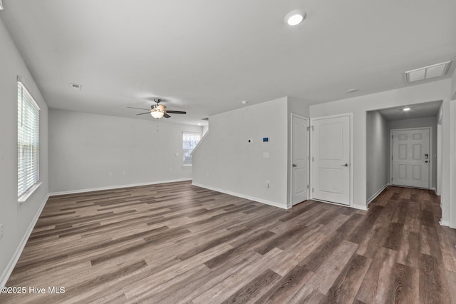 unfurnished living room with ceiling fan and dark wood-type flooring