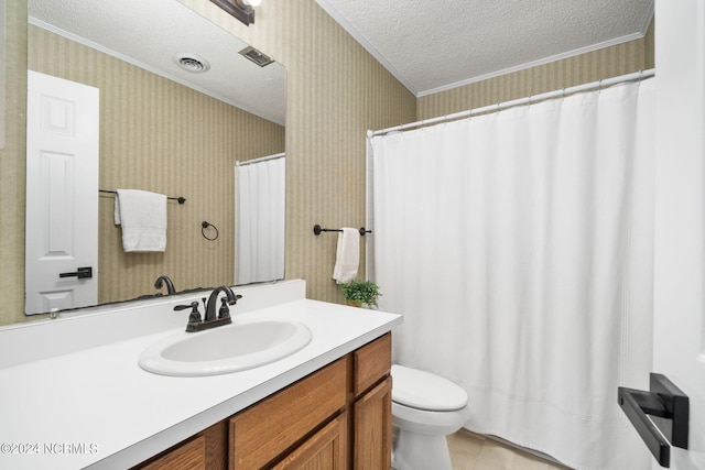 bathroom with vanity, ornamental molding, toilet, and a textured ceiling