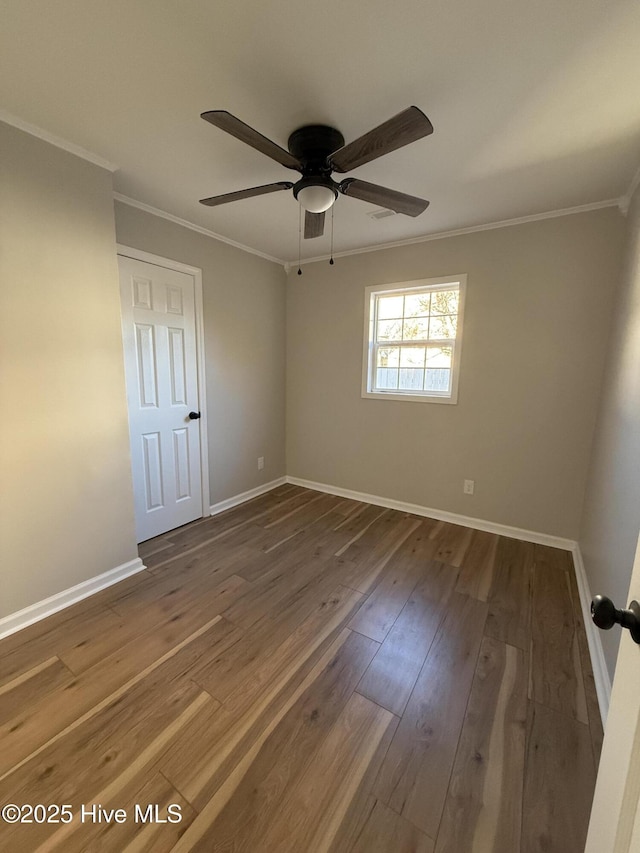 spare room with crown molding, ceiling fan, and hardwood / wood-style flooring