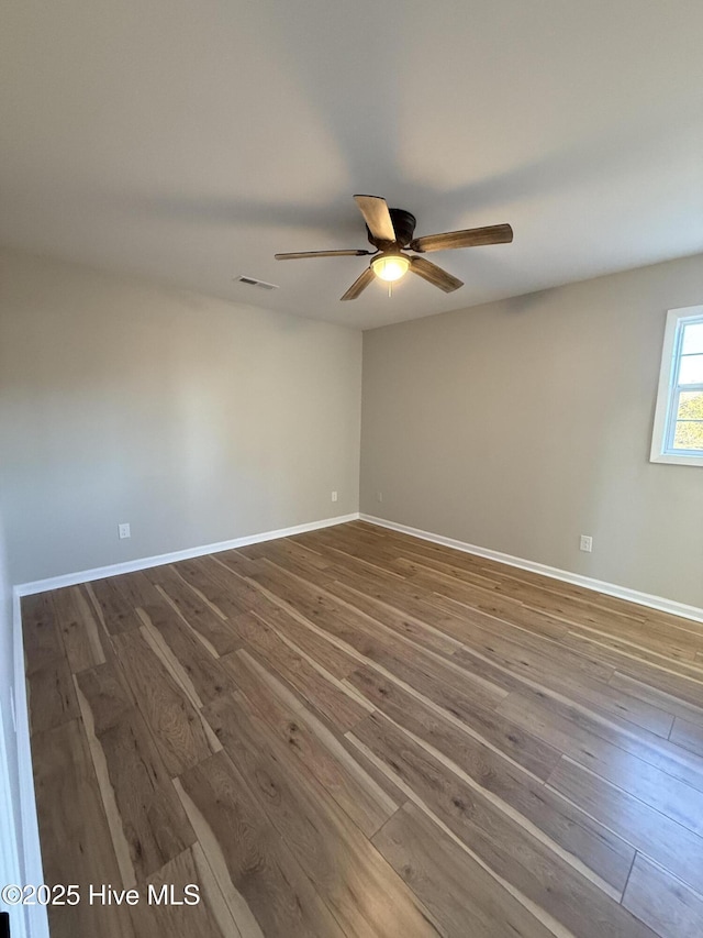 empty room with hardwood / wood-style flooring and ceiling fan