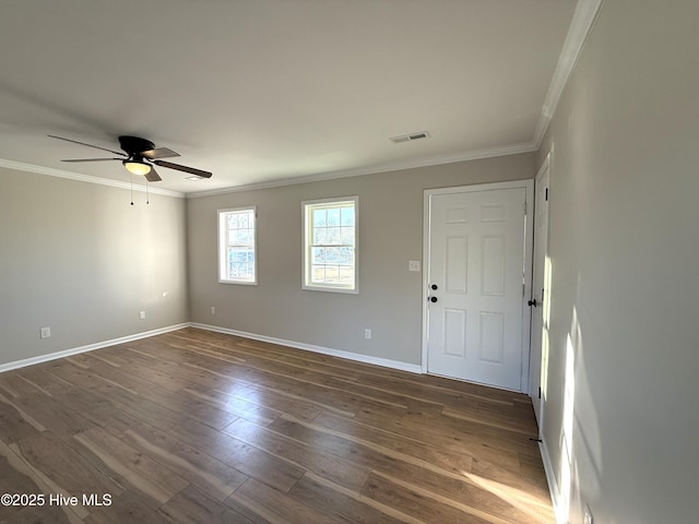 empty room featuring ceiling fan, dark hardwood / wood-style floors, and ornamental molding