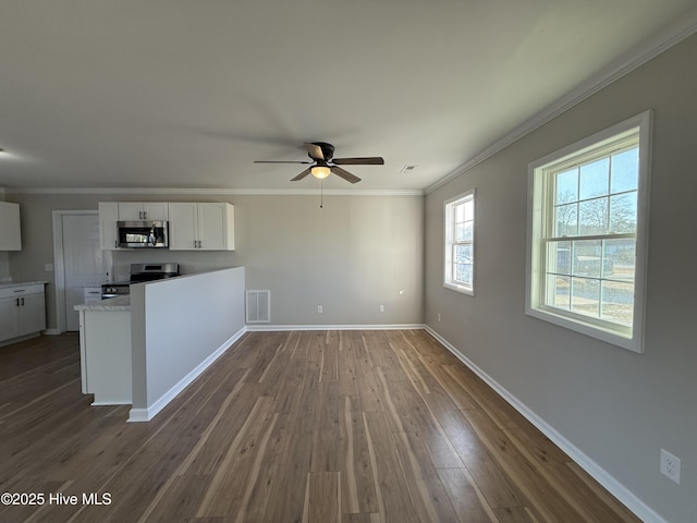 unfurnished living room featuring ceiling fan, ornamental molding, and dark wood-type flooring