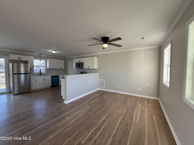 interior space featuring white cabinetry, ceiling fan, dark wood-type flooring, appliances with stainless steel finishes, and ornamental molding