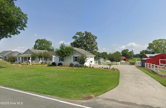 view of front of house with an outbuilding and a front yard