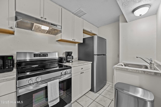 kitchen featuring white cabinets, sink, appliances with stainless steel finishes, and a textured ceiling