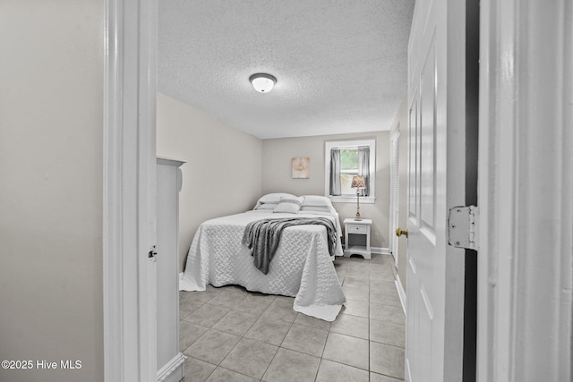 tiled bedroom with a textured ceiling