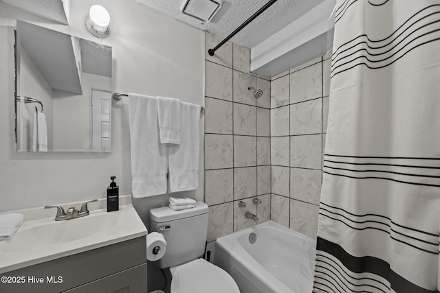 full bathroom with shower / tub combo with curtain, vanity, a textured ceiling, and toilet