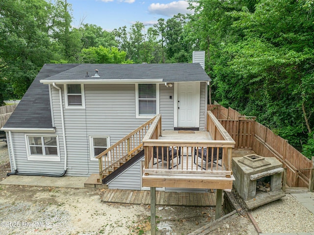 rear view of property featuring a deck