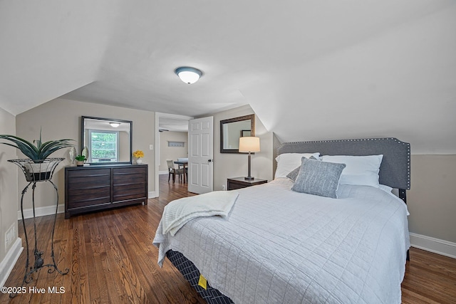 bedroom featuring dark hardwood / wood-style floors and lofted ceiling