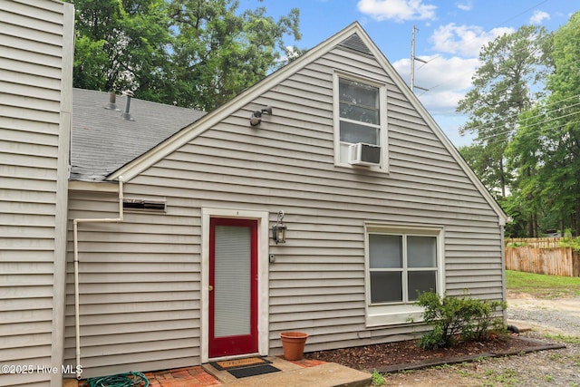 rear view of property with cooling unit