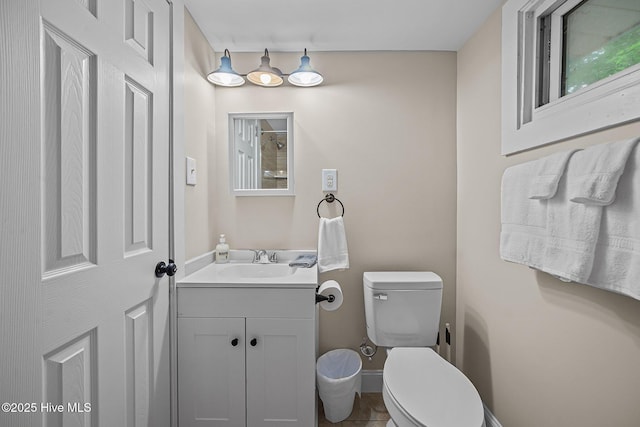 bathroom featuring tile patterned floors, vanity, and toilet