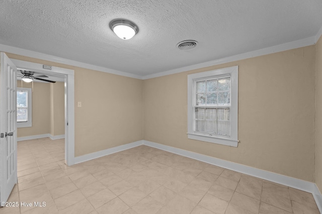 spare room with a textured ceiling, ceiling fan, and ornamental molding