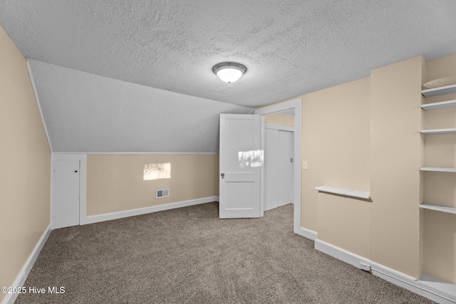 bonus room with carpet flooring, a textured ceiling, and lofted ceiling