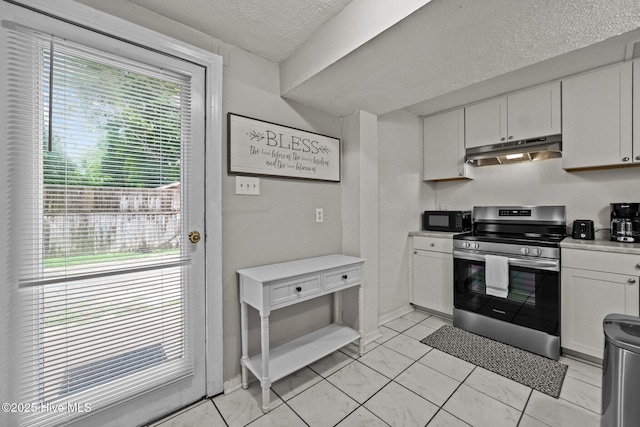 kitchen with stainless steel range, white cabinets, and a textured ceiling