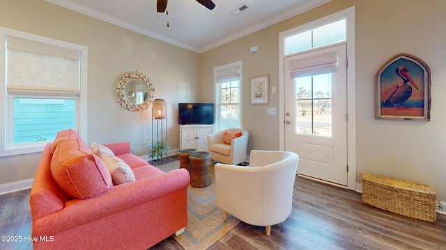 living room featuring ceiling fan, ornamental molding, and dark wood-type flooring