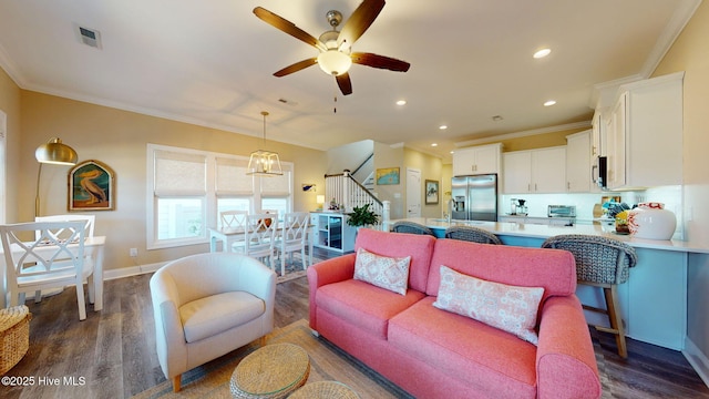 living room with crown molding, ceiling fan, and dark wood-type flooring