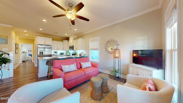 living room featuring ceiling fan, dark wood-type flooring, and ornamental molding