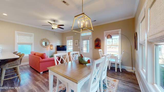 dining space featuring ceiling fan with notable chandelier, dark hardwood / wood-style floors, and ornamental molding